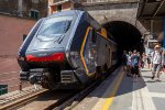 A Hitachi "Rock" EMU departs north into the tunnel at Vernazza